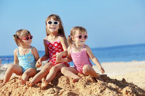 A laughing group of children in the sand
