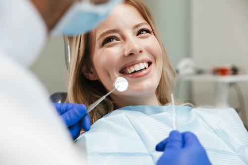 Woman smiling in treatment chair at dentist in Brandon, FL