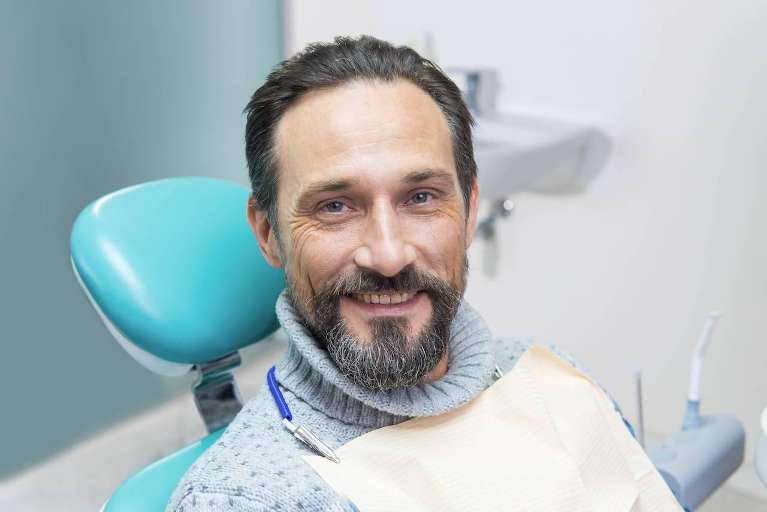 older man sitting in a dental chair in brandon 